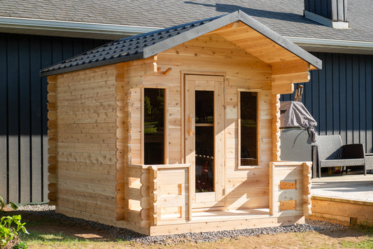 Outdoor sauna cabin with a covered porch and bench seating